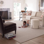 Girl drawing laying on area rug | Pierce Carpet Mill Outlet