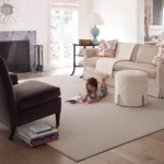 Girl laying on Area rug | Pierce Carpet Mill Outlet